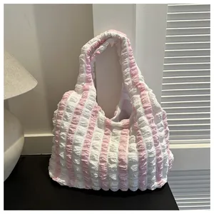 Detail of pink and white striped popcorn fabric on a large capacity puffy tote bag