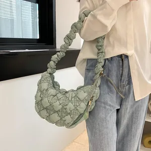 Detail of light green cloud bag with quilted bubble texture and ruffled shoulder strap
