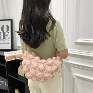 Close-up of soft pink quilted cloud bag featuring stylish ruched bubble texture detail