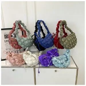 Detailed view of cloud bubble bags in eight vibrant colors with pleated texture