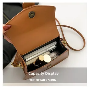 Internal view of brown small square bag showing capacity for phone and cosmetics