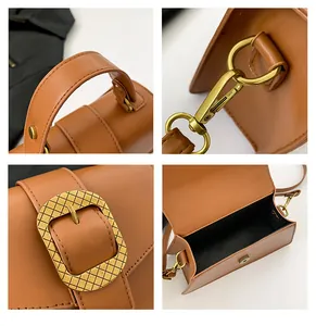 Detail view of brown leather handbag featuring gold hardware, wide handle and magnetic closure