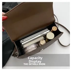 Interior capacity of brown croc-effect crossbody bag showing daily essentials