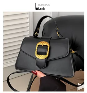 Close-up of black PU leather handbag featuring a textured golden circular buckle and handle