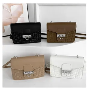 Detail of multi-color crossbody bags showing embossed textures and silver buckles