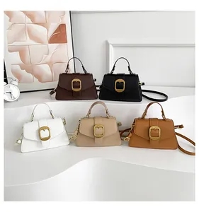 Detail of five stylish trapezoid crossbody bags in deep brown, black, white, beige, and camel