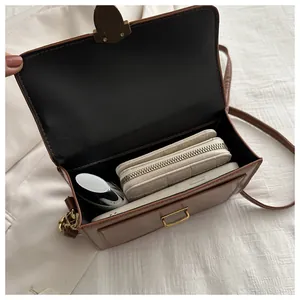 Interior view of brown vintage crossbody bag showing storage space for phone and wallet