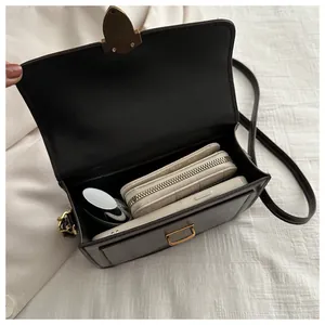 Close-up of brown vintage crossbody bag interior showing phone and wallet capacity