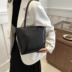 Minimalist black glossy leather tote bag for women, stylish large shoulder bag for commuting