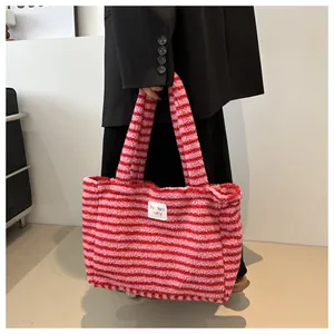 Detailed plush texture of pink striped tote bag with fun party label detail