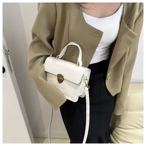 Detail of white matte leather handbag featuring FANYISSA logo and metallic clasp closure