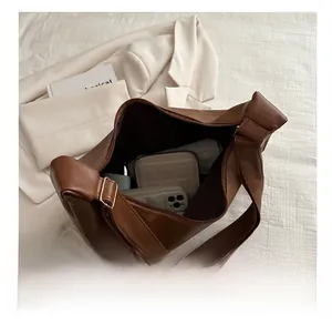 Large capacity brown soft leather shoulder bag interior showing storage space
