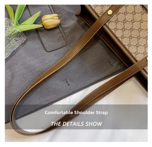 Detail of comfortable brown leather shoulder straps on a vintage canvas tote bag