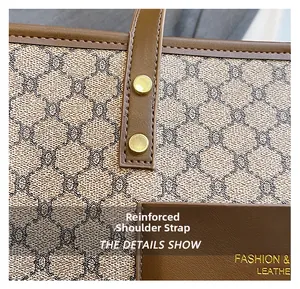 Close-up of reinforced shoulder strap with gold rivets on vintage patterned tote bag