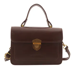 Retro dark brown leather handbag with gold shield lock and adjustable strap for women