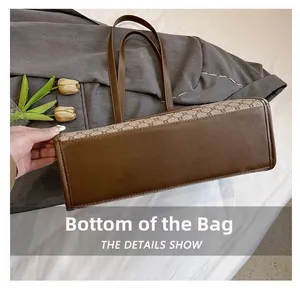 Detailed bottom view of large brown tote bag showing smooth leather and monogram canvas