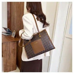 Detailed macro view of retro geometric pattern and brown leather pocket on tote bag
