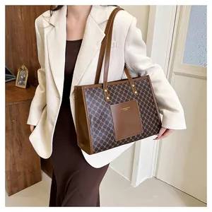Detail of vintage monogram tote bag with brown leather front pocket and sturdy shoulder straps