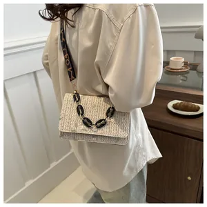 Lace flower embroidery on beige textured mini bag with geometric wide strap detail