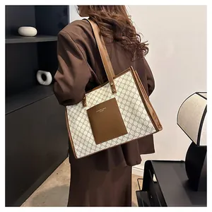 Detail of vintage monogram tote bag featuring brown leather pocket and gold text print