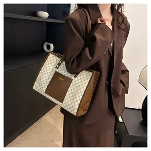 Close-up of retro canvas tote bag with brown leather pocket and geometric patterns