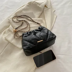 Chic black quilted bucket bag with gold chain strap and drawstring closure for women