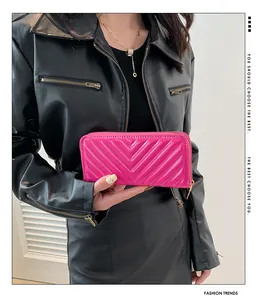 Close-up of hot pink chevron quilted leather wallet with gold zipper detail