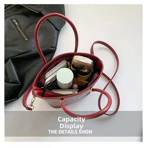 Interior view of the burgundy hobo bag showing large capacity for umbrella and makeup