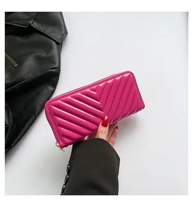 Detailed view of hot pink chevron quilted patent leather long wallet for women