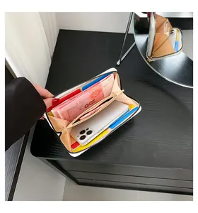 Detailed interior of a white quilted wallet showing spacious card slots and phone pocket