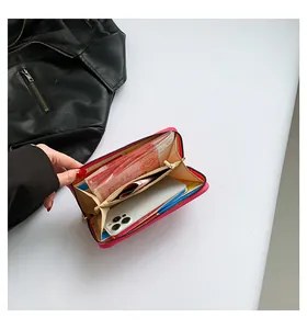Macro view of magenta leather wallet showing multi-slot interior and gold zipper detail