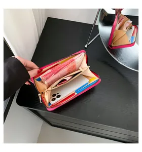 Internal view of high-capacity magenta long leather wallet showing slots and phone space