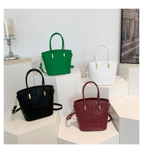 Detailed display of crocodile embossed tote bags in four colors with gold hardware