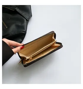 Detailed interior of women's long leather wallet with multi-card slots and zip pocket
