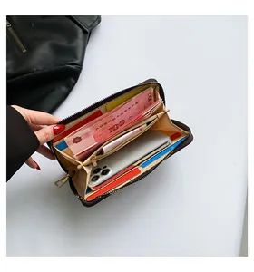 Interior view of black quilted long wallet with multiple card slots and zipper compartment
