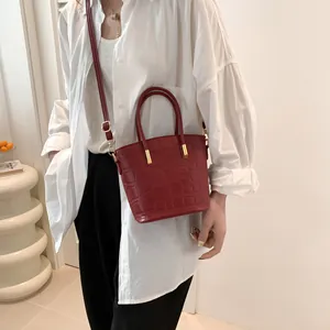 Deep red crocodile texture tote bag with gold hardware and crossbody strap for women