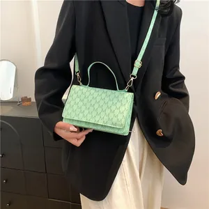 Mint green crossbody bag with M-letter print and adjustable strap for women