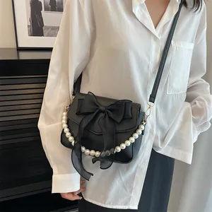 French lace pearl crossbody bag with oversized bow detail for a chic aesthetic look