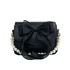 Elegant black bow shoulder bag with luxury pearl handle and matte leather finish