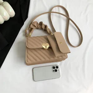 Sac à main beige matelassé avec fermoir coeur, poignée froncée et pochette