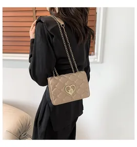 Détail du sac bandoulière matelassé marron clair avec fermoir doré en forme de cœur