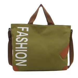Green canvas tote bag with FASHION print and brown leather accents for commuting