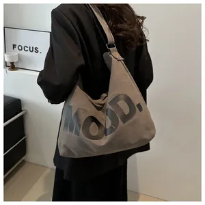 Detail of large dark brown canvas tote bag with bold black MOOD. letter printing