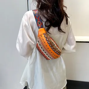 Detailed back view of ethnic crossbody bag with colorful woven patterns and orange leather trim