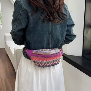 Rear view of model wearing ethnic crossbody bag with colorful woven patterns