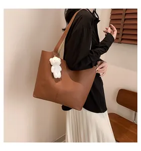 Brown faux leather tote bag with litchi grain and cute white plush bear pendant