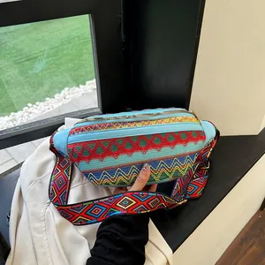 Close-up of bohemian colorful woven chest bag with geometric patterns and wide strap