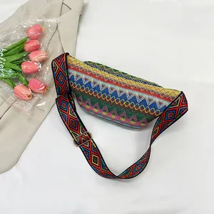 Top view of bohemian woven crossbody bag with geometric patterns and golden metal buckles