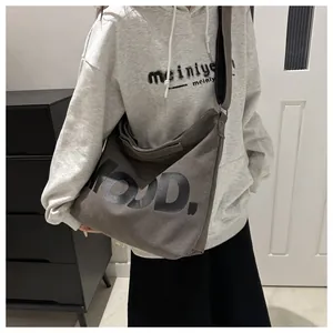 Detail shot of the large charcoal canvas tote bag with MOJD lettering and wide strap