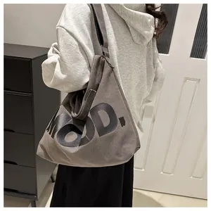 Detail of dark grey canvas crossbody bag with MOOD lettering and adjustable strap